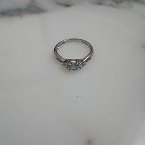 Sterling silver and cubic zirconia ring with light blue stone and white/clear